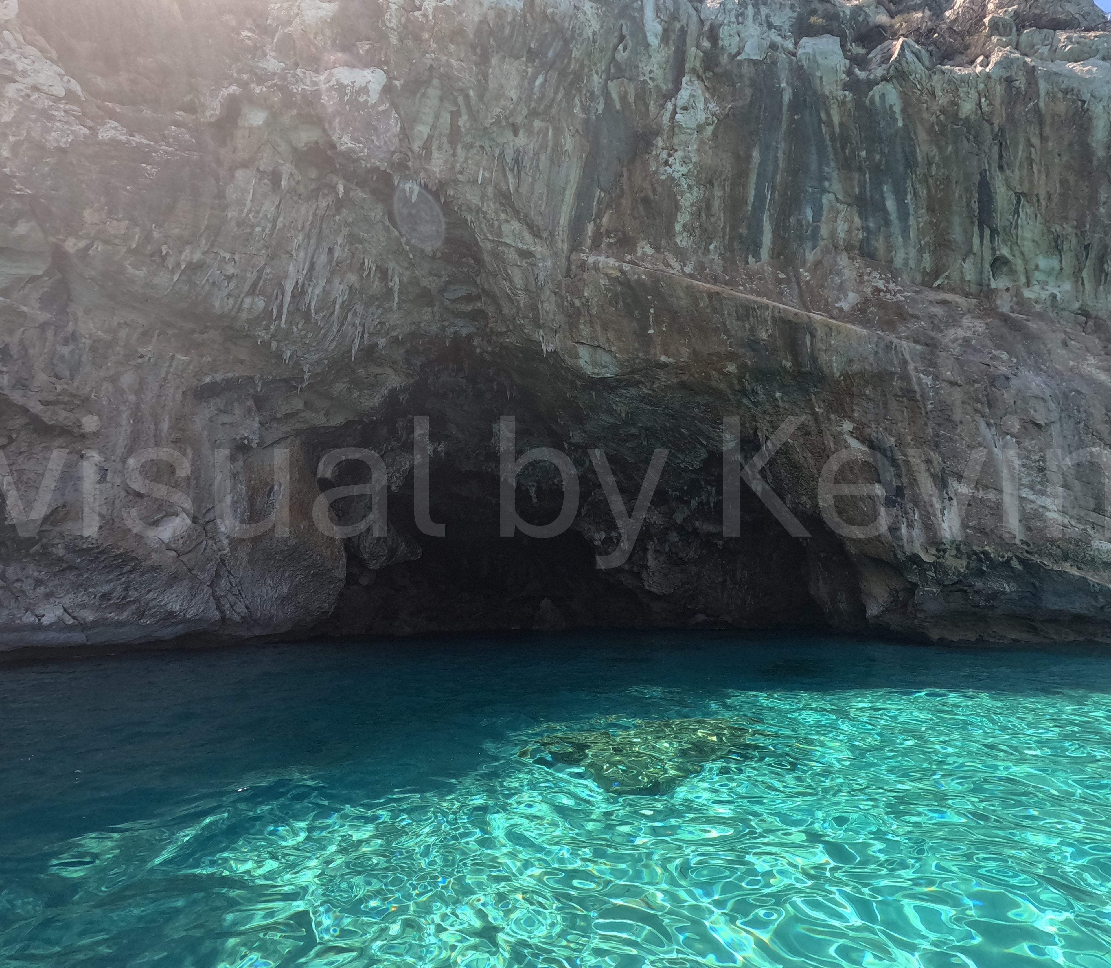 Rock grotto with turquoise-blue water