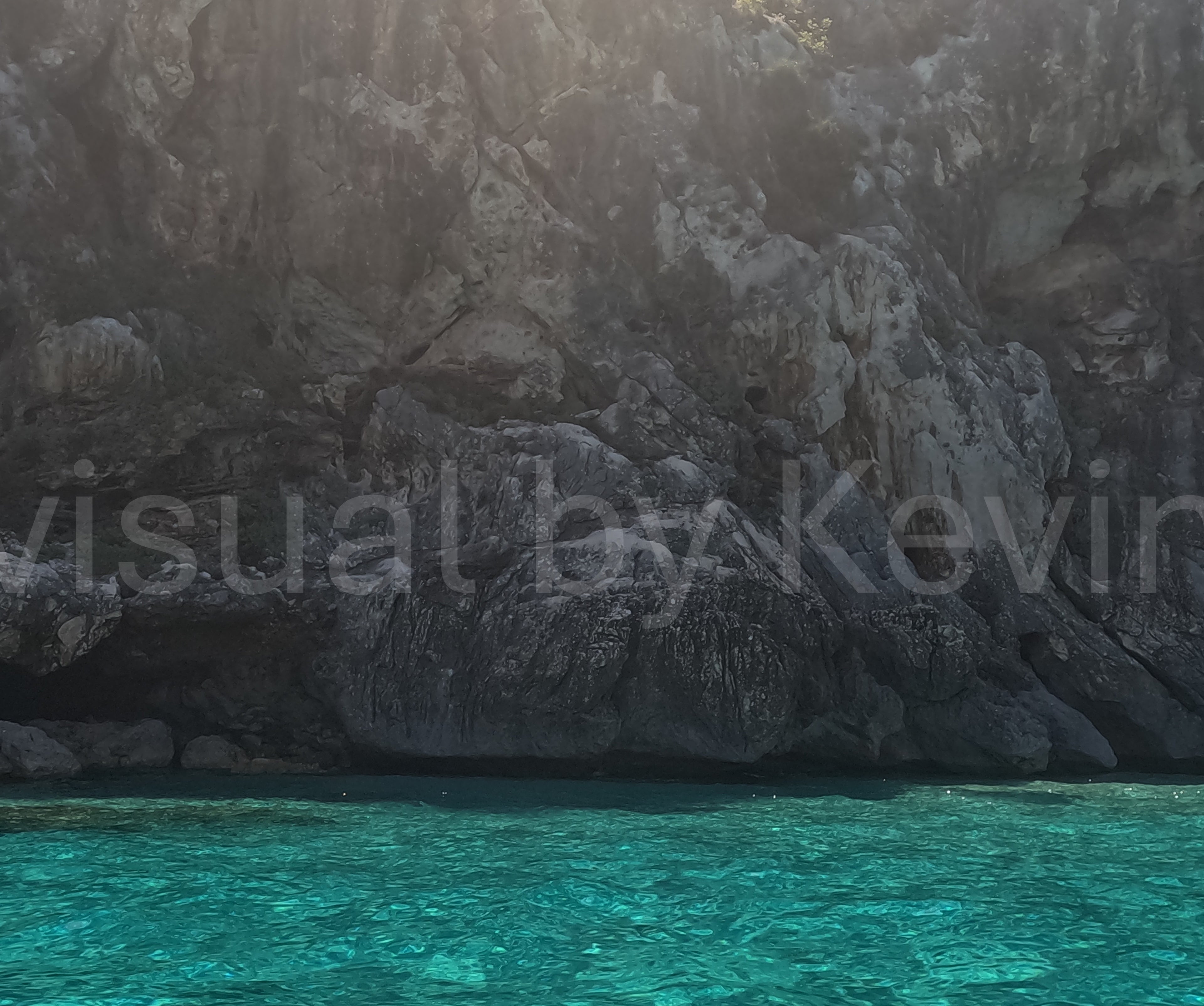 Sunlight hits cliff face by the sea