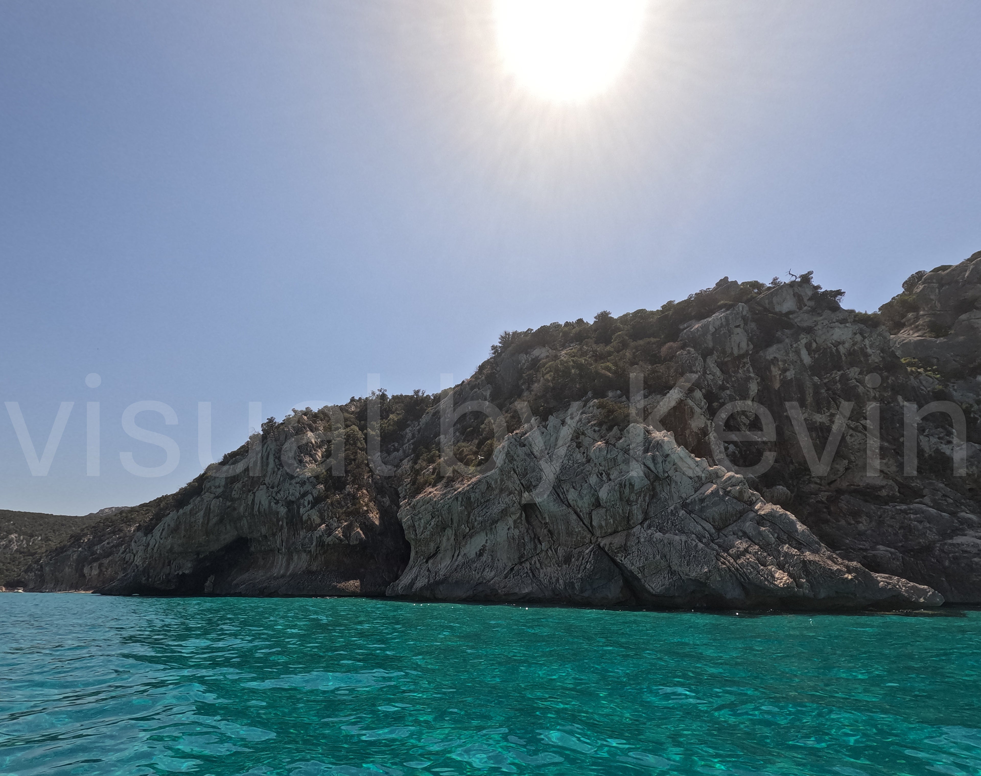Sun over rocky coast