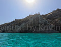 Sun over rocky coast