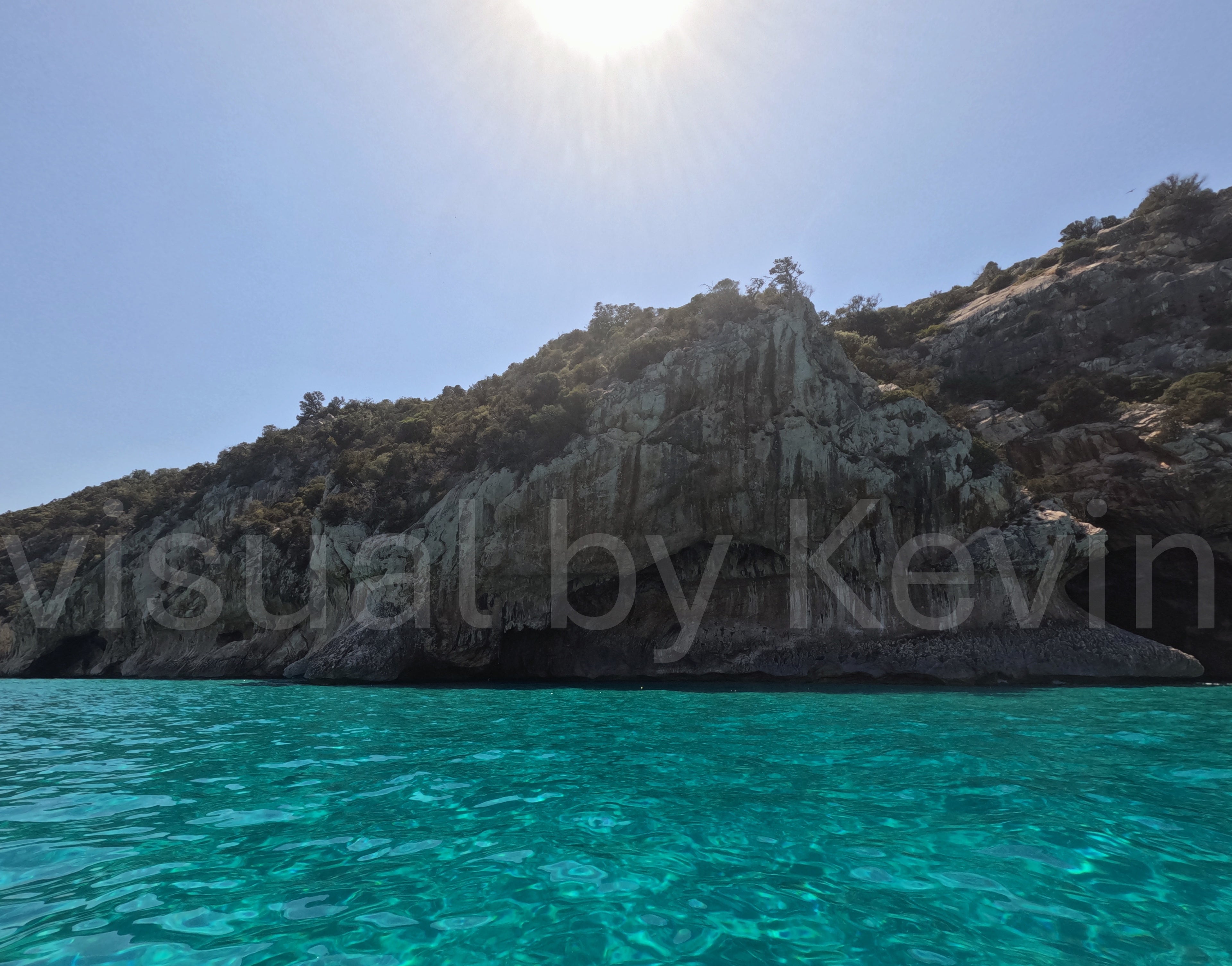 Sun over rocky coast